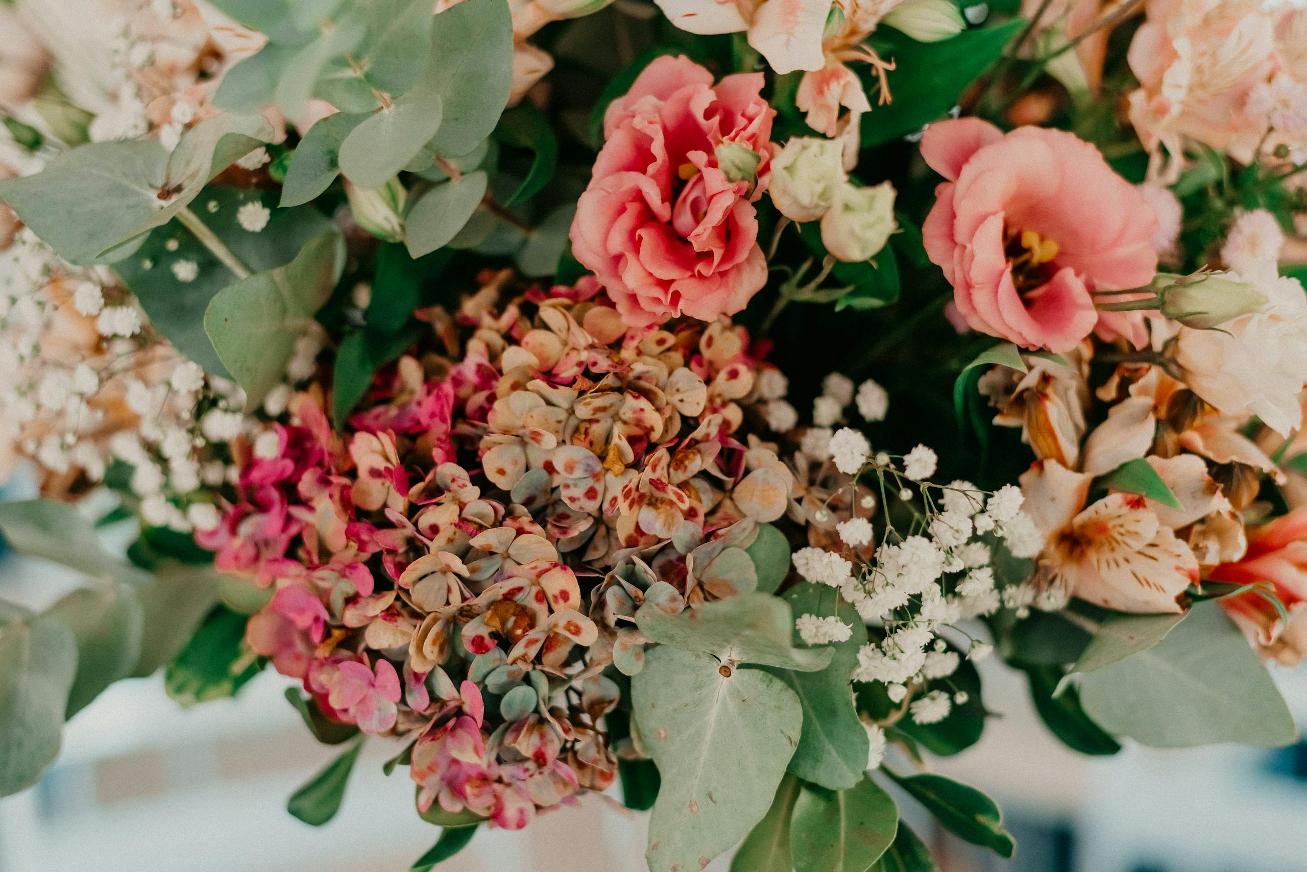 Colorful floral bouquet featuring hydrangeas, roses, and baby's breath in a vibrant arrangement.