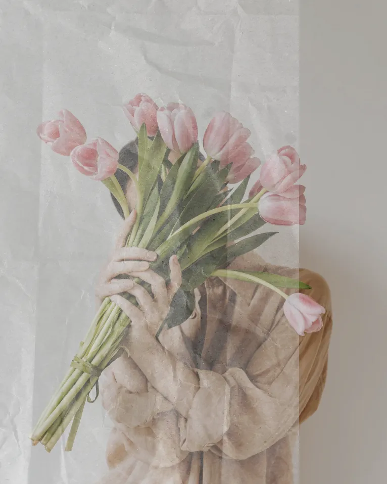 soft neutral image of woman holding pink tulips