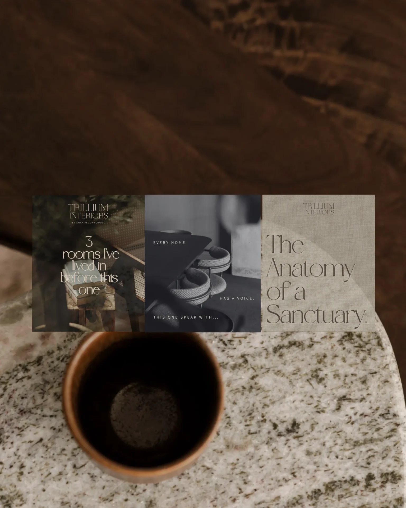 Overhead view of a speckled countertop with a brown coffee mug in the foreground and three book covers laid side by side in the background.