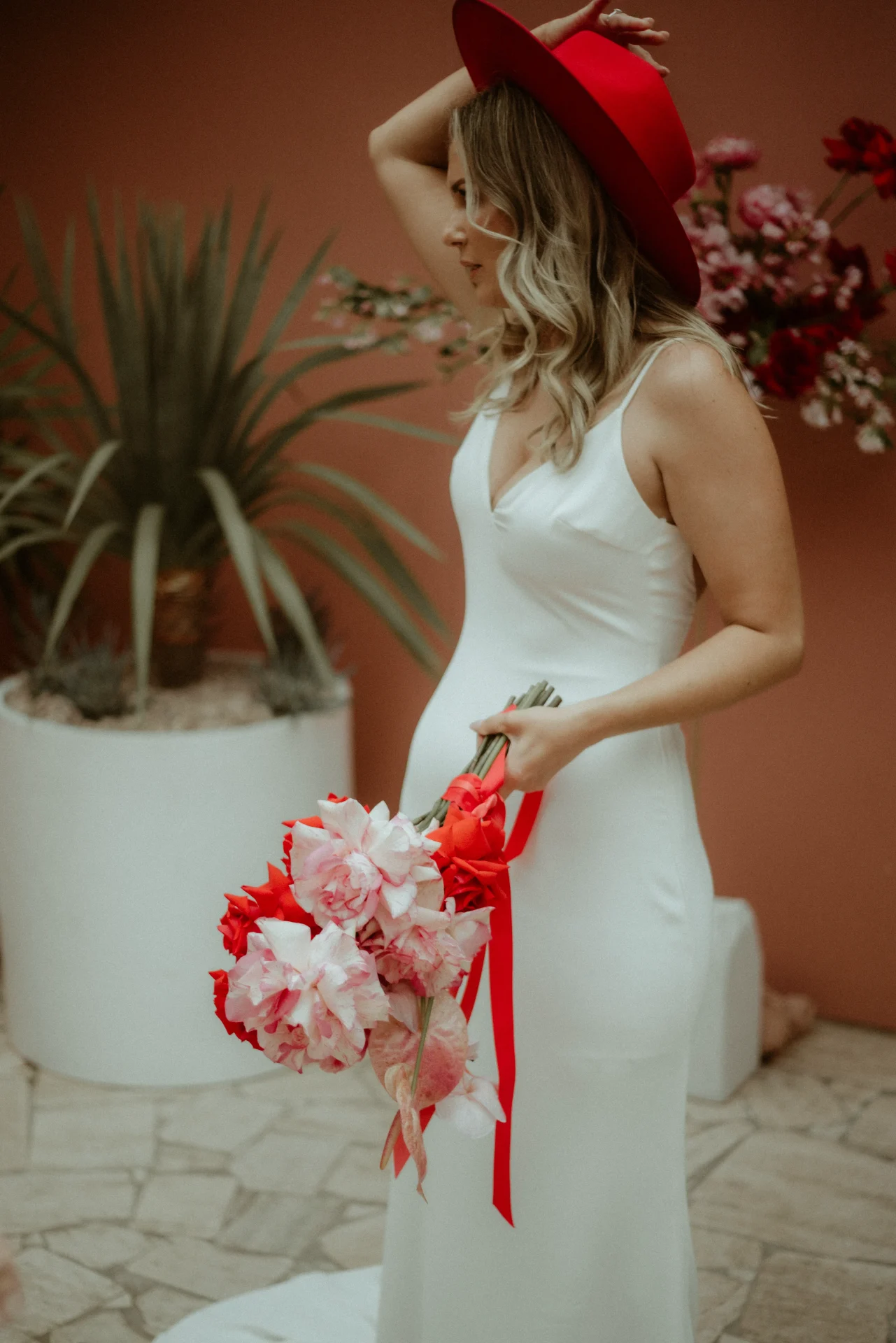 Maeve Wedding Floristry website design with terracotta background, hand-stamped yellow floral logo, handwritten Maeve wordmark, black and white couple photography, and a tulip photo, wedding florist branding by The Good Canvas
